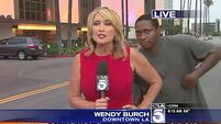 Man scares the bejaysus out of reporter on live TV