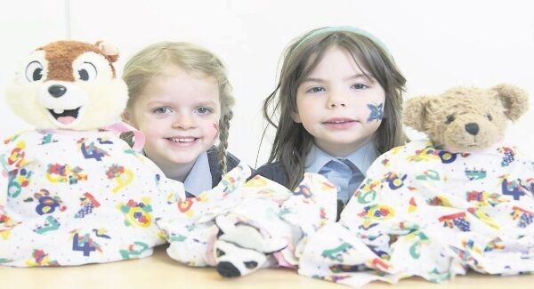Rudy Keating and Kerrie Porter from St John the Baptist National School, Midleton, Co Cork, wit h Emme Bear and Belle as students from UCC’s School of Medicine reopened UCC’s College of Medicine and Health Teddy Bear Hospital. Picture: Gerard McCarthy