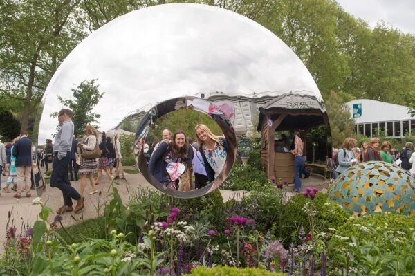 Gill Puxley and Caroline Poppe looking through a sculpture by David Harber at the flower show.