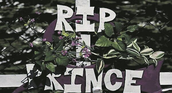 Prince fans leave a RIP sign at a memorial wall outside the Paisley Park compound. Pic: Getty