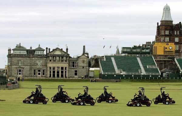 Six members of a nine-person lawn mowing crew mow the fairway in front of the Royal and Ancient Golf Club Sunday, July 10, 2005 on the Old Course at St. Andrews, Scotland. The workers were preparing the course for golfers scheduled to take practice rounds Sunday for the British Open.