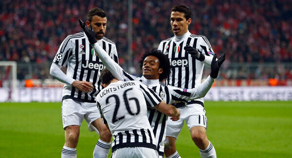 Juventus' goalscorer Juan Cuadrado raises his arms as he and his teammates celebrate their side's second away goal. Photo: AP / Matthias Schrader Juventus' goalscorer Juan Cuadrado raises his arms as he and his teammates celebrate their side's second away goal. Photo: AP / Matthias Schrader