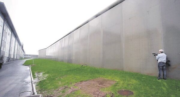 The entire complex is separated by an imposing 7.2m, or 24-ft high perimeter concrete wall. The exercise yards are 50m from the wall, aimed to deter the smuggling of contraband. Picture: Eddie O’Hare