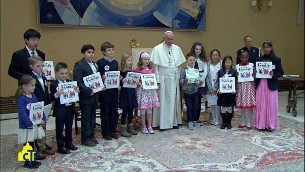Clare Ó Gormáin (with the hairband and white cardigan), standing to the right of Pope Francis. Clare Ó Gormáin (with the hairband and white cardigan), standing to the right of Pope Francis.