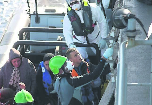 The crew help refugees to board the LÉ Samuel Beckett. Picture: Dan Linehan
