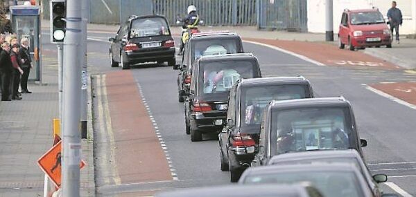 The cortege departs for the cemetery following the funeral Mass at the Church of the Most Holy Redeemer