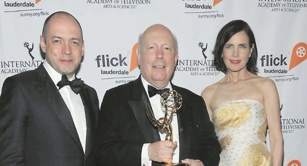 Downton Abbey executive producer Gareth Neame and star Elizabeth McGovern with creator Julian Fellowes, who won an International Emmy for the show