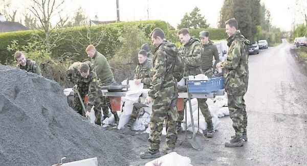 Army personnel from the 12th Battalion, Sarsfield Barracks, filling sandbags to protect homes after the flooding in east Clare