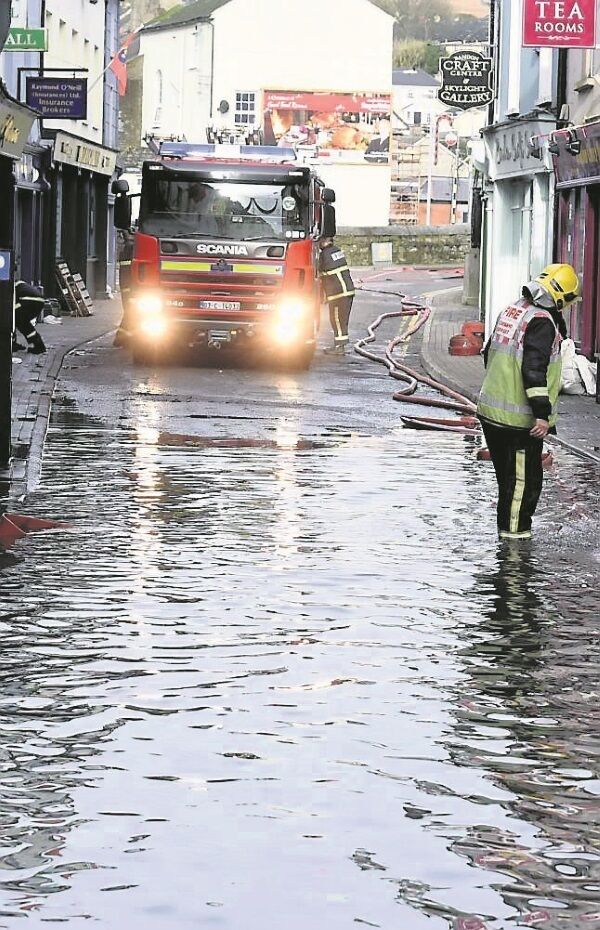 Fire service personnel continued, until approximately 3pm, to pump water from the streets of Bandon town after flooding overnight. Picture: Larry Cummins