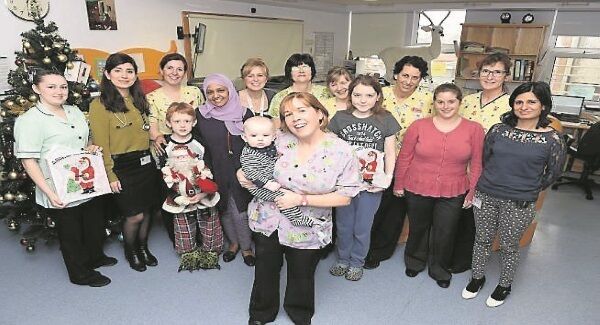 Mercy University Hospital St Anne’s Ward staff and young patients with (front) Sinead Favier, ward manager holding six-month-old Mickie in the paediatric ward.