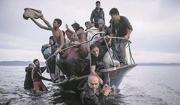 Refugees arriving by boat near the village of Skala on Lesbos, Greece Refugees arriving by boat near the village of Skala on Lesbos, Greece