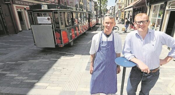 Michael Haulie O’Neill (left) of O’Neill Butchers and Kevin O’Regan of Fuchsia Footwear on Pearse Street as the resurfacing and drainage scheme nears completion in Clonakilty. Picture: Denis Minihane