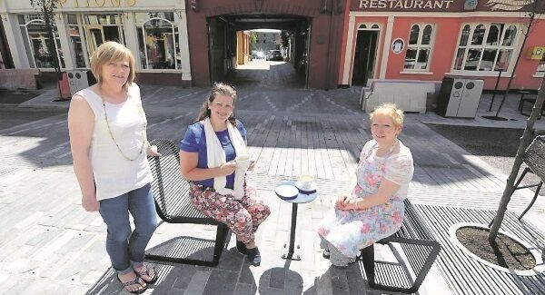 Enjoyng the new street furniture on Pearse Street as the resurfacing and drainage scheme nears completion were (from left) Rose O’Regan, Cóisir Gift Shop; Marie Kirby, Clonakilty, and Geraldine Kingston, Gearoidín’s Restaurant. Picture: Denis Minihane