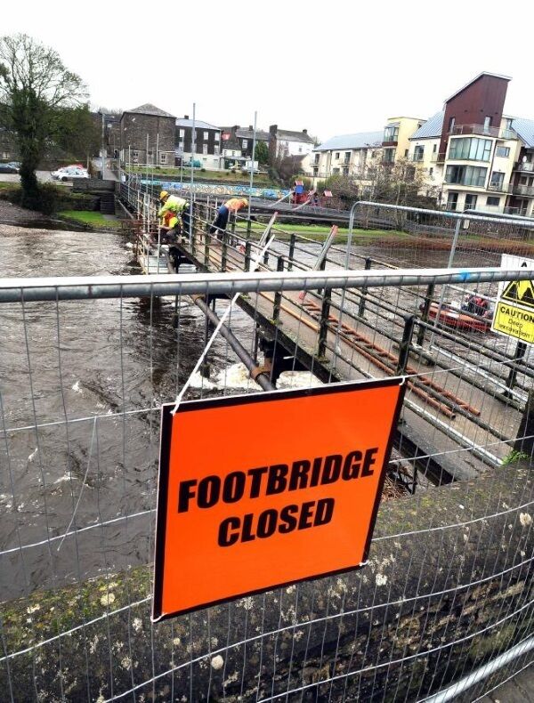 Working repairing storm damage on the pedestrian bridge over the River Bandon. Picture: Denis Scannell Working repairing storm damage on the pedestrian bridge over the River Bandon. Picture: Denis Scannell