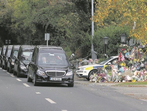 The funeral cortege passes the the Carrickmines temporary halting site, where 10 people died by fire almost two weeks ago The funeral cortege passes the the Carrickmines temporary halting site, where 10 people died by fire almost two weeks ago