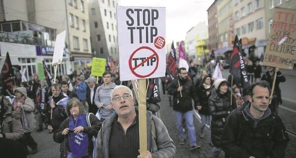 A man in Hanover, Germany, holds a poster with the slogan Stop TTIP during a protest of thousands of demonstrators against the trade deal. A majority of people in Germany now view TTIP negatively. A man in Hanover, Germany, holds a poster with the slogan Stop TTIP during a protest of thousands of demonstrators against the trade deal. A majority of people in Germany now view TTIP negatively.