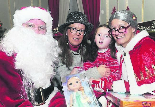 Skye Worthington and her mother Colleen meeting Santa and Mrs Claus during the Cork City Hospitals Children’s Club Fota House trip.