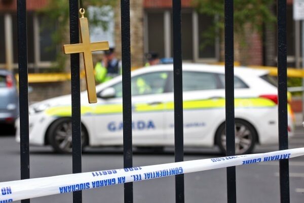 A cross tied to railings at the scene of the shooting dead of Gareth Hutch at Avondale House flats complex on North Cumberland Street on Tuesday morning. Picture: Colin Keegan/Collins Dublin