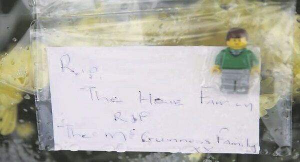 A note left with flowers outside the home of the Hawe family, who died in a suspected murder-suicide. Picture: Brian Lawless/PA Wire