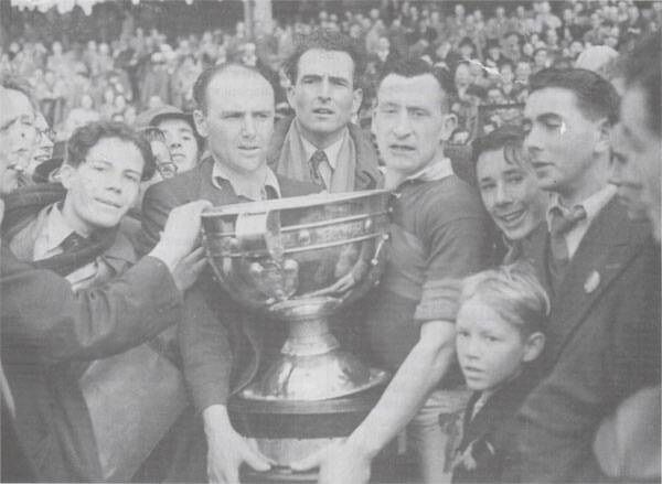 Mayo captain Sean Flanagan with the Sam Maguire and some Mayo supporters after the 1950 All-Ireland final. Picture: The Mayo News