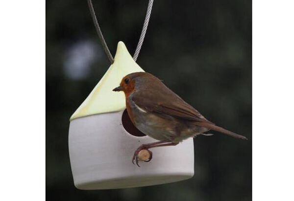 A robin arrives for a meal at one of Mary Neeson’s birdfeeders.