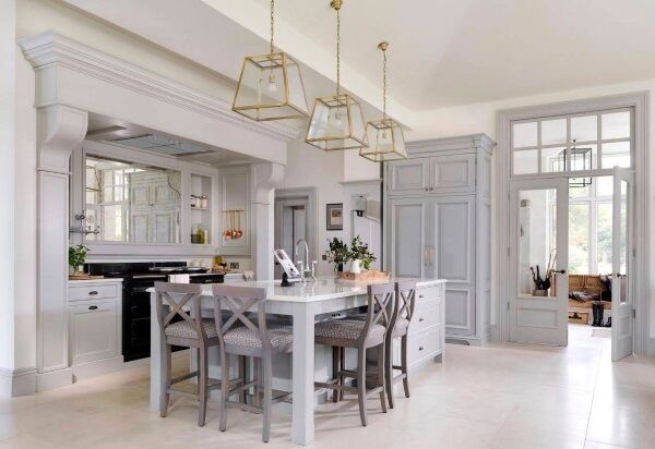 Mixing it up: A country kitchen by designer Andrew Ryan, features complimentary but distinct door styles and hand crafted bronze ironmongery. There are two secretly concealed storage larders in the columns at either side of the large Aga oven in a kitchen which lets luxurious space dictate a layout beyond the expected triangle, andrewryan.ie.