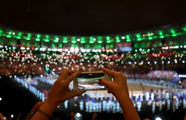 An audience member films video on their iPhone during the opening ceremony of the 2016 Rio Paralympic Games. Apple has sold over 1bn iPhones in the past decade, having introduced 11 generations of the device.