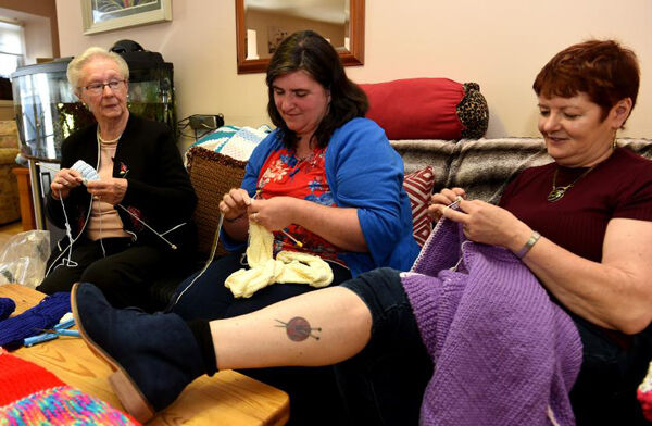 (right) Margaret Kelleher shows off her ’knitting’ tattoo on her leg with (left) Una Dineen and (middle) Imelda Mulcahy as they make ’Blankets of Hope’.