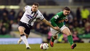 Dundalk’s Brian Gartland takes on Cork City’s Sean Maguire last season