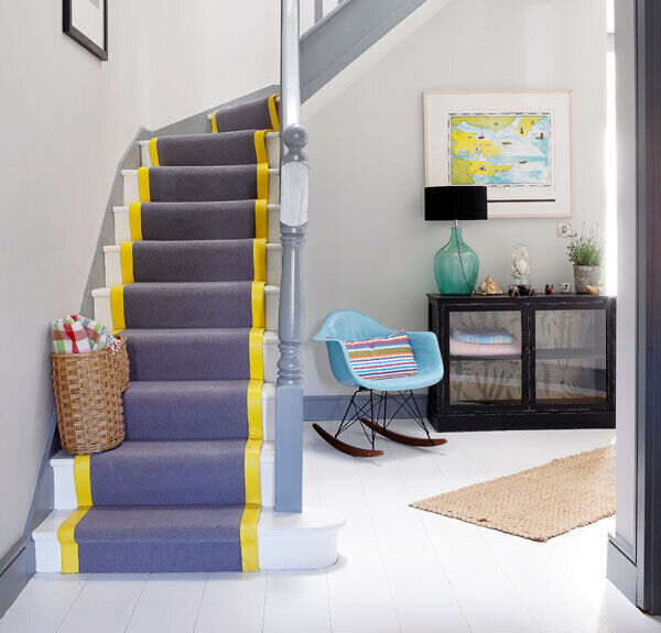 Staircase and hallway in Sandymount by Optimise. The yellow stripe on the stairs carpet lifts a subtle grey composition.