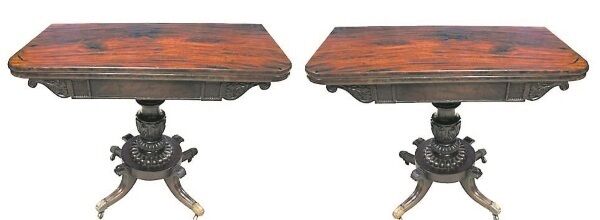 A PAIR OF REGENCY, IRISH, MAHOGANY FOLD OVER TEA TABLES, with rounded edges, and carved foliage decorated freize beneath, both raised on turned, and carved with acanthus leaf decoration central support, leading to a circular base, with four shaped and carved legs, terminating with brass paw feet on castors, date circa 1810 at Hegarty’s Auction on 9th May 2017 est. €6,000-8,000