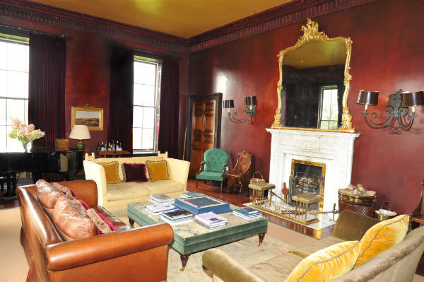 The drawing room. Note the almost lacquered, deep crimson finish on the walls.