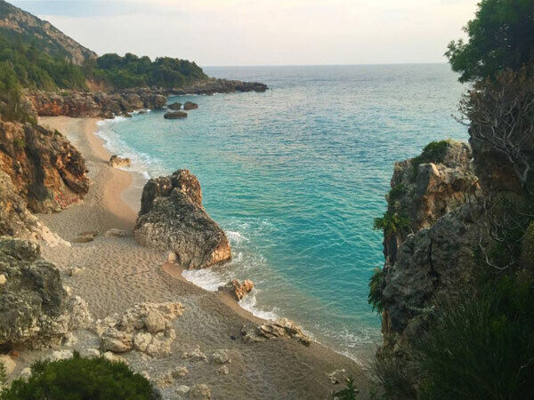 Gjipe beach is idyllic and remote; accessible via a long drive down a narrow, winding mountain road through fragrant olive groves after the town of Dhermi on the main road.