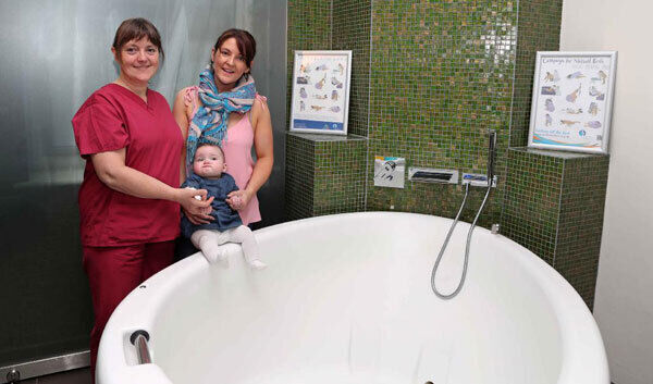 Lynda Moore, a midwife with the Domino scheme, with Mary and Lily Rose McGahern in CUMH’s pool room.