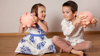 Children holding their piggy bank