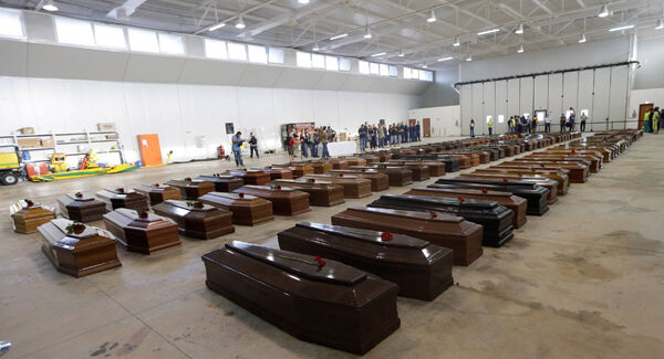 Coffins of died migrants are lined up inside a hangar of Lampedusa’s airport, Italy.