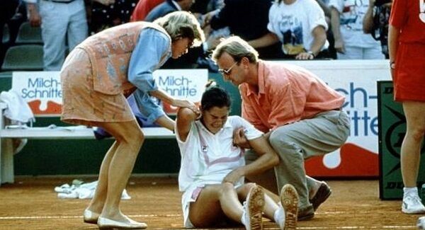 Monica Seles is tended to after being stabbed by a crazed fan of her rival Steffi Graff during a tournament in Germany.
