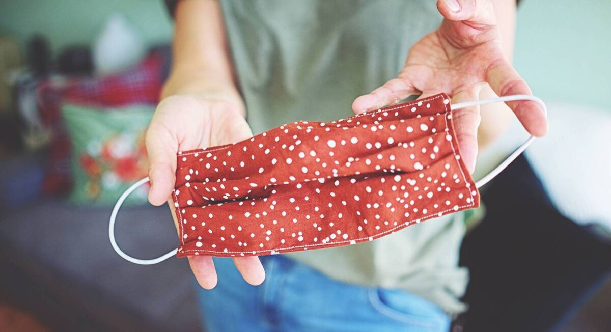 CLOTH FACE MASKS : Young woman shows self-made mask to protect against virus and bacteria