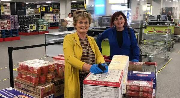 Yvonne Qullligan and Patricia Cotter with some of the packages of food for delivery. Friendly Call has augmented its service to fight isolation during the pandemic.