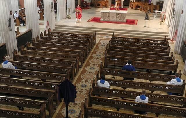 Socially distanced choir members in the pews (Brian Lawless/PA)