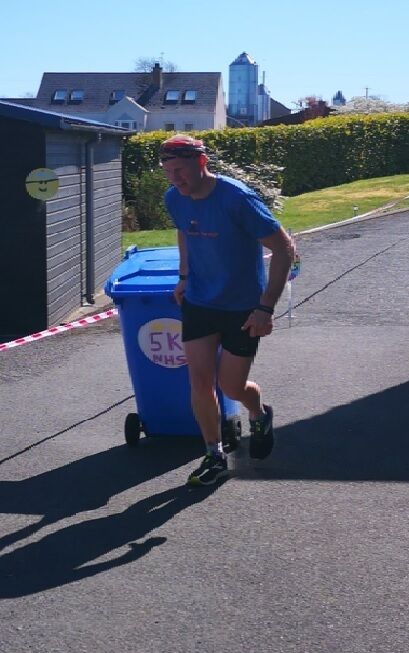 This time Mr Clarke dragged a wheelie bin to raise money for the NHS (Keith Clarke PA)