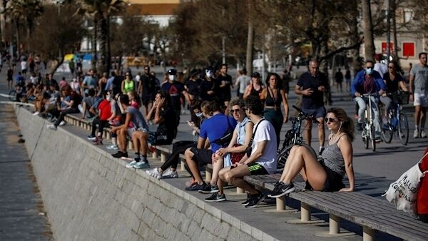 People exercise on Barcelona's seafront promenade today.