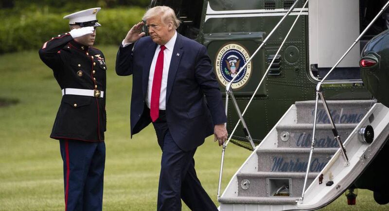 US president Donald Trump salutes as he steps out of Marine One on the South Lawn at the White House.