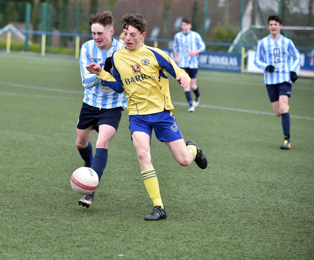 Douglas Hall's Roger Timon is tackled by Salthill Devon's Luke Fitzpatrick during the under 16 SFAI Sketchers National cup quarter final at Moneygourney . Picture: Eddie O'Hare