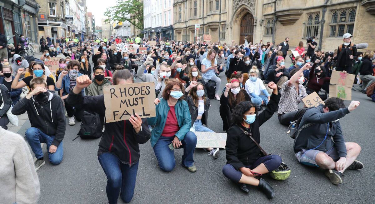 People calling for the removal of the statue of 19th-century imperialist, politician Cecil Rhodes from an Oxford college today. Pic: Steve Parsons/PA Wire