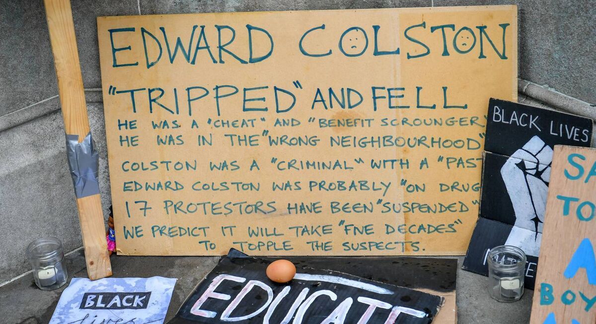 Signs and placards at the base of the Edward Colston statue plinth in Bristol city centre following a raft of Black Lives Matter protests took place across the UK over the weekend. Pic: Ben Birchall/PA Signs and placards at the base of the Edward Colston statue plinth in Bristol city centre following a raft of Black Lives Matter protests took place across the UK over the weekend. Pic: Ben Birchall/PA