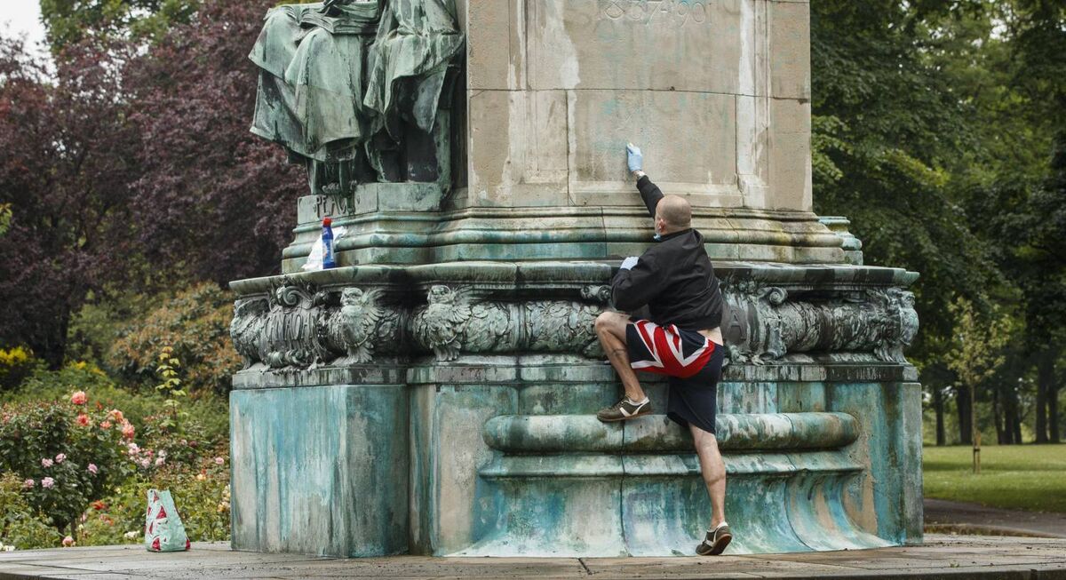 A member of the public cleans graffiti, that included the letters BLM and the words "murderer" and "slave owner", from a statue of Queen Victoria in Woodhouse Moor, Leeds, England. Pic: Danny Lawson/PA Wire A member of the public cleans graffiti, that included the letters BLM and the words "murderer" and "slave owner", from a statue of Queen Victoria in Woodhouse Moor, Leeds, England. Pic: Danny Lawson/PA Wire