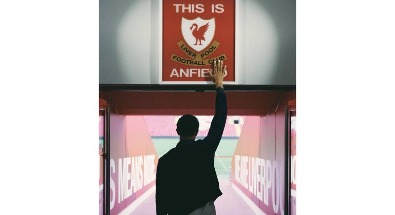 TOUCHING GREATNESS: Liverpool full-back Trent Alexander-Arnold pays due respect to the iconic sign that teams pass as they emerge from the tunnel at Anfield. Picture: Getty Images