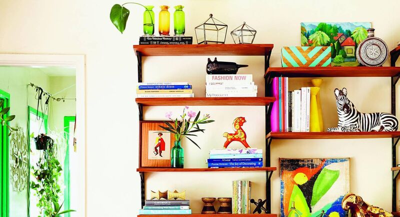 If you’re not brave enough to introduce wall colour to a room, try colourful objects on a shelf instead.