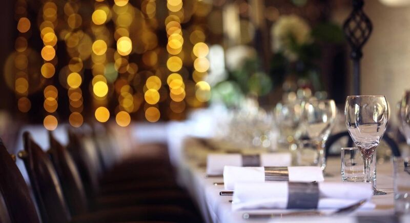 A man and a woman dining under a plastic shield in a Paris restaurant. Photo: AP Photo/Thibault Camus